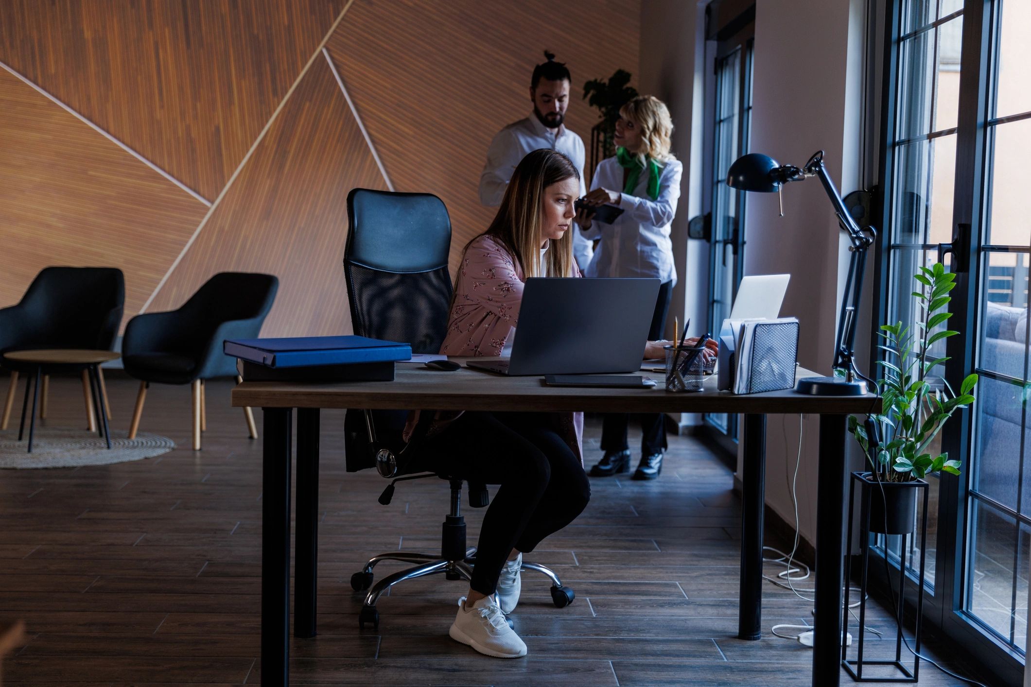 Business professional working on a laptop in a modern office