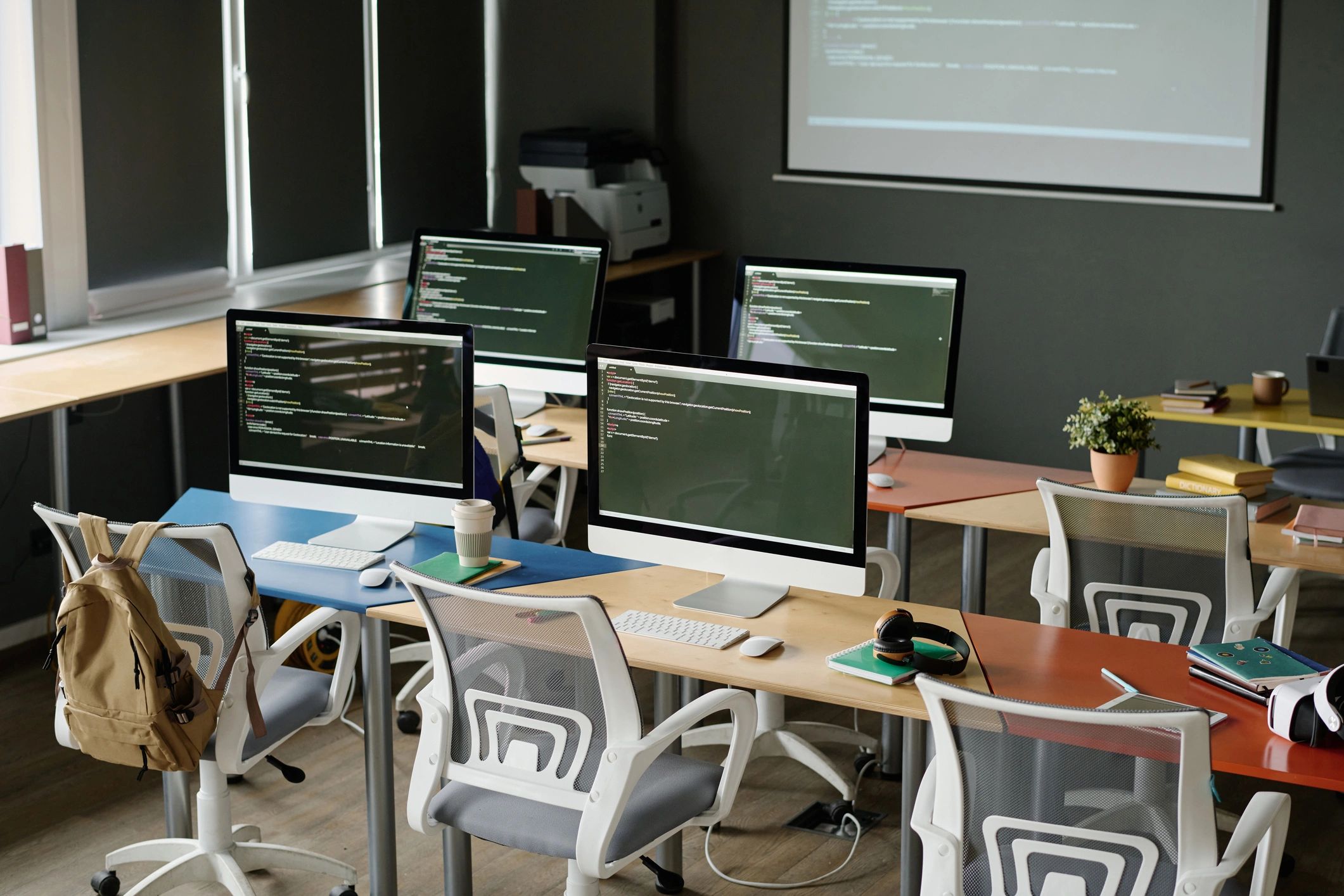 Modern IT workspace with multiple computers and copy space