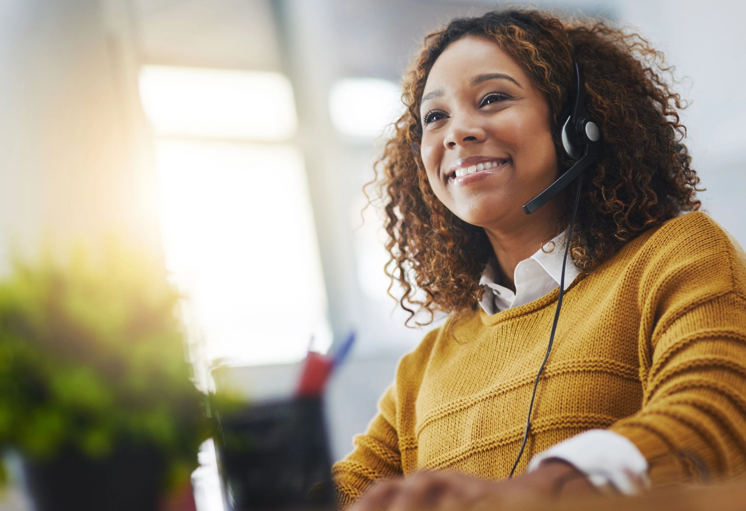 Customer support agent working at a call center desk